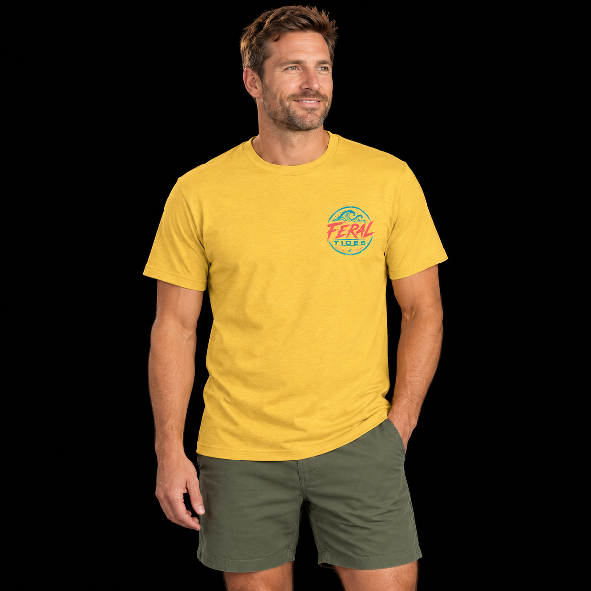 Male model wearing the Heather Mellow Yellow Feral Tides Tidal Rebel Tee, standing with one hand in pocket and looking right, showing the small coral-and-teal wave logo on the front chest against a solid black background.