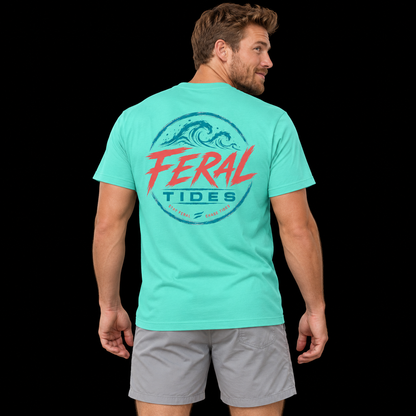 Male model wearing the Mint Feral Tides Tidal Rebel Tee, looking back over right shoulder with arms relaxed, showing the large coral-and-teal wave graphic on the back against a solid black background.