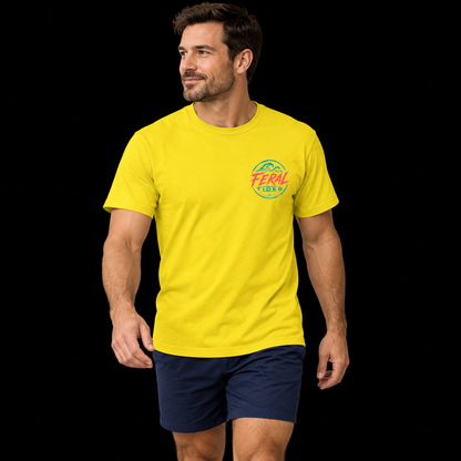 Male model wearing the Sunshine Feral Tides Tidal Rebel Tee, walking casually with arms relaxed, showing the small coral-and-teal wave logo on the front chest against a solid black background.