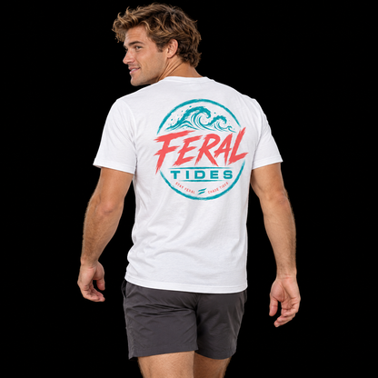 Male model wearing the White Feral Tides Tidal Rebel Tee, looking back over left shoulder with arms relaxed, showing the large coral-and-teal wave graphic on the back against a solid black background.