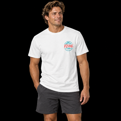 Male model wearing the White Feral Tides Tidal Rebel Tee, standing casually with one hand in pocket, showing the small coral-and-teal wave logo on the front chest against a solid black background.